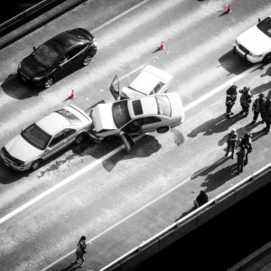 A black and white photo of a car accident seen from above.