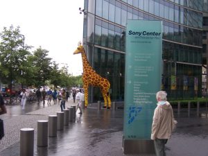 A giraffe sculpture in a city.