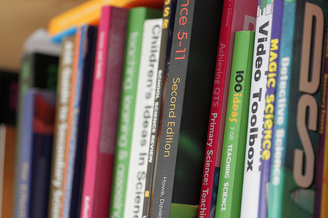 About a dozen books on a bookshelf