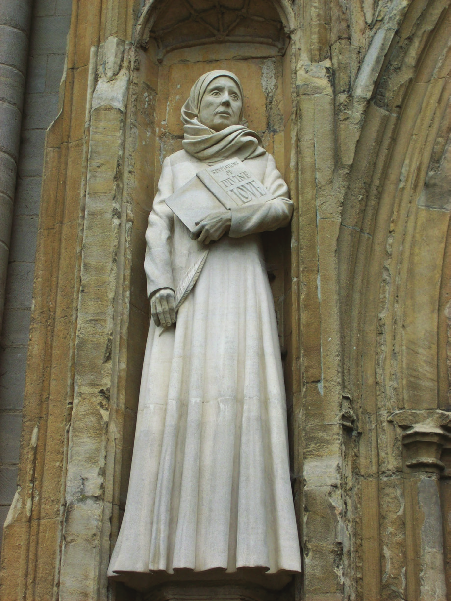 Image of a statue of a woman holding a book